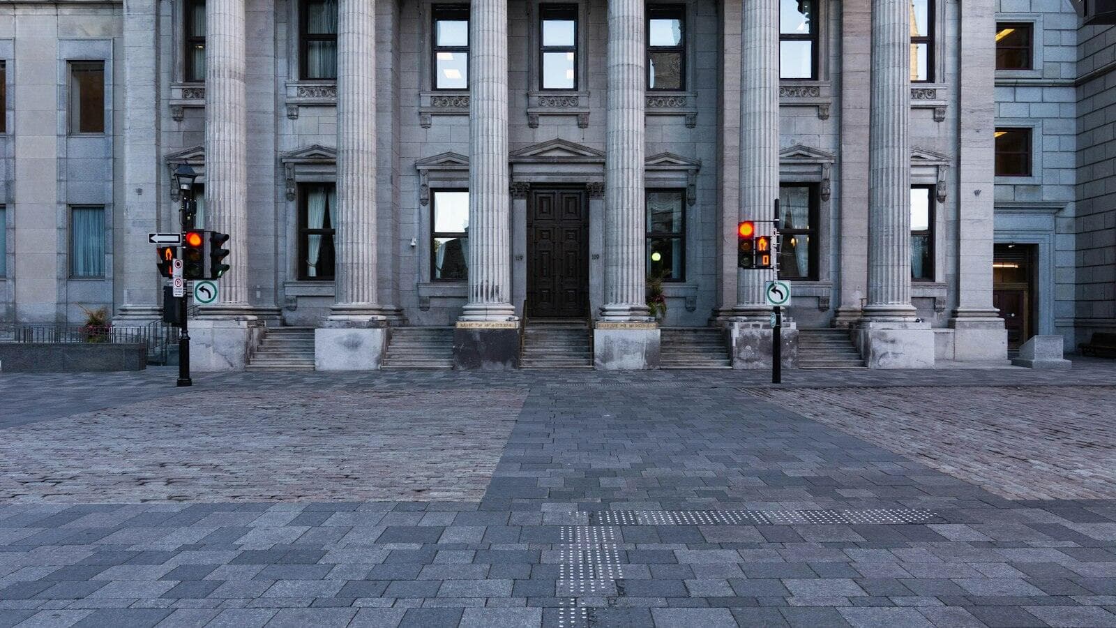 The stone facade and columns of a bank building