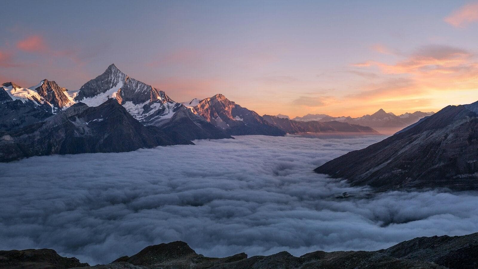 Mountains above a sea of clouds at sunrise